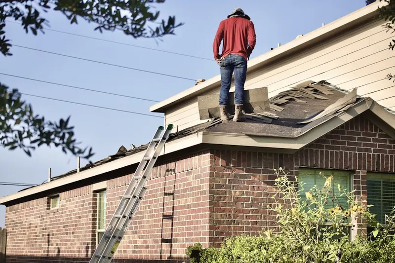 Professional roofer working on a residential roof in Marlton Heights